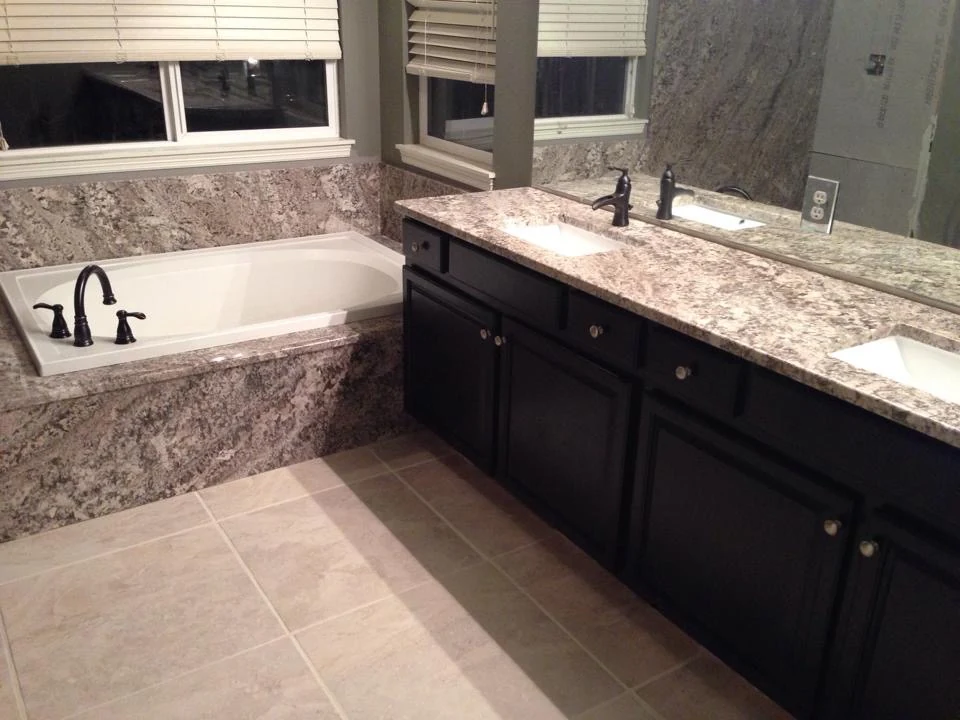 Bathroom vanity beside a tiled inset bathtub