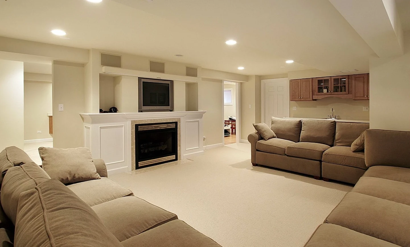 Living area with pale sofas, a fireplace and built-in shelving