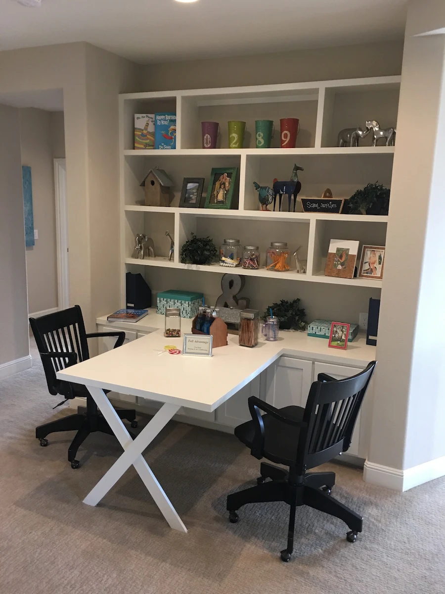 Home office with a desk and white built-in shelving